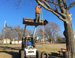 Man Standing In Tractor End Front Loader